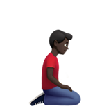 kniender Mann: dunkle Hautfarbe, nach rechts